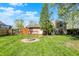 Backyard with large grassy area, firepit, wooden deck, and recreational vehicle at 251 Yorktown Rd, Greenwood, IN 46142