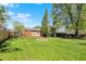 A well-maintained lawn in the backyard, complemented by a fire pit and rear deck at 251 Yorktown Rd, Greenwood, IN 46142