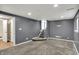 Finished basement features neutral carpet, gray walls, recessed lights, and stairway to upper level at 251 Yorktown Rd, Greenwood, IN 46142