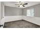Neutral bedroom features gray walls, a carpeted floor, and a ceiling fan with an attached light at 251 Yorktown Rd, Greenwood, IN 46142