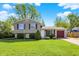 Charming two-story home with stone accents, manicured lawn, and attached garage on a sunny day at 251 Yorktown Rd, Greenwood, IN 46142