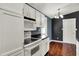 Kitchen features white cabinets, black counters and stainless steel range and microwave at 251 Yorktown Rd, Greenwood, IN 46142