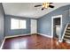 Bright living room featuring a large window, hardwood flooring, and stairs to an upper level at 251 Yorktown Rd, Greenwood, IN 46142