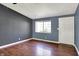 Bright living room featuring a large window, hardwood flooring, and a neutral color palette at 251 Yorktown Rd, Greenwood, IN 46142