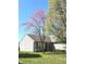 Inviting one-story home with blooming redbud tree and well-maintained front lawn at 2629 Calabash Dr, Indianapolis, IN 46217