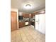 Functional kitchen featuring tile flooring, oak cabinets, and white appliances at 2629 Calabash Dr, Indianapolis, IN 46217