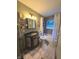 This bathroom features a vanity, toilet and tub with shower with a mosaic stained glass window for interest at 2650 Woodrow Ave, Indianapolis, IN 46241