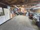 Spacious garage featuring overhead lighting, workbench, storage solutions, and garage door at 2650 Woodrow Ave, Indianapolis, IN 46241