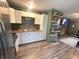 Well-lit kitchen featuring white cabinets, stainless steel appliances, and open access to the living area at 2650 Woodrow Ave, Indianapolis, IN 46241