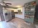 Bright kitchen with white cabinets, stainless steel appliances, and decorative wall shelving at 2650 Woodrow Ave, Indianapolis, IN 46241