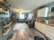 Open concept living room shows a cozy seating area with decorative shelves and connection to the kitchen at 2650 Woodrow Ave, Indianapolis, IN 46241