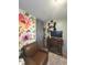 Cozy living room with an electric fireplace, sitting area and a statement floral wall hanging at 2650 Woodrow Ave, Indianapolis, IN 46241
