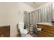 Cozy bathroom featuring a toilet, mirror, and wooden vanity, offering a functional space at 314 N Reisner St, Indianapolis, IN 46222