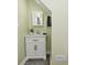 Bathroom features a single vanity with a white cabinet, dark pulls, and sleek faucet at 344 N Addison St, Indianapolis, IN 46222
