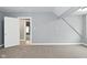 Neutral bedroom with gray walls, carpeted floors, bright lighting, and white paneled doors at 344 N Addison St, Indianapolis, IN 46222