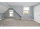 Neutral bedroom with gray walls, carpeted floors, bright lighting, and white paneled doors at 344 N Addison St, Indianapolis, IN 46222