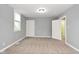 Neutral bedroom with gray walls, carpeted floors, bright lighting, and white paneled doors at 344 N Addison St, Indianapolis, IN 46222