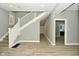 Inviting foyer with wood-look floors, staircase, and neutral gray walls at 344 N Addison St, Indianapolis, IN 46222