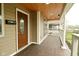View of a well-maintained front porch with wood flooring and a decorative front door at 344 N Addison St, Indianapolis, IN 46222