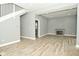 Open living room featuring wood-look floors, gray walls, and a modern fireplace at 344 N Addison St, Indianapolis, IN 46222