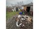 Messy backyard with scattered debris, garbage bags, and assorted discarded items, showing signs of neglect at 3742 S Walcott St, Indianapolis, IN 46227