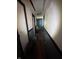 Narrow hallway with black trim doors and walls that need repair and cleaning at 3742 S Walcott St, Indianapolis, IN 46227