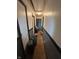 Narrow hallway with black trim doors and walls that need repair and cleaning at 3742 S Walcott St, Indianapolis, IN 46227