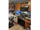 Reveals a stainless steel oven, a microwave, wooden cabinets, and laminated floors but is in need of decluttering at 3742 S Walcott St, Indianapolis, IN 46227