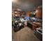 Presents a stainless steel oven, microwave, wooden cabinets, and laminated floors that is in need of decluttering at 3742 S Walcott St, Indianapolis, IN 46227