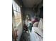 Image of a cluttered utility room with a door leading to the exterior at 3742 S Walcott St, Indianapolis, IN 46227