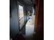 Image of a cluttered utility room with exposed wiring and a door leading to the exterior at 3742 S Walcott St, Indianapolis, IN 46227