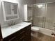 Updated bathroom with tile flooring, modern vanity, and combined tub and shower at 379 Vinewood N Dr, Brownsburg, IN 46112