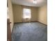 Clean and well-lit bedroom with neutral walls, plush carpeting, and a large window at 379 Vinewood N Dr, Brownsburg, IN 46112