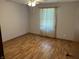 A bedroom featuring wood floors, a ceiling fan, and a large window for natural light at 379 Vinewood N Dr, Brownsburg, IN 46112