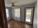 Bedroom features hardwood floors, a white door and curtains, neutral walls, and outdoor views at 379 Vinewood N Dr, Brownsburg, IN 46112