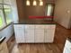 Kitchen island featuring dark countertops, ample storage, and hardwood flooring at 379 Vinewood N Dr, Brownsburg, IN 46112