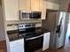 Kitchen showcasing stainless steel appliances, white cabinets, and stylish backsplash at 379 Vinewood N Dr, Brownsburg, IN 46112