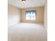 Bright and airy bedroom with light-colored carpet and a window with a blue curtain at 4061 Melbourne Dr, Columbus, IN 47203