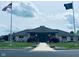 Charming clubhouse featuring an American and Indiana state flag, with manicured landscaping and inviting entrance at 4061 Melbourne Dr, Columbus, IN 47203