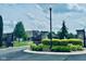 Secured community entrance with decorative iron gates and stone pillars, surrounded by manicured landscaping at 4061 Melbourne Dr, Columbus, IN 47203