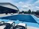 Community pool with lounge chairs and a protective cover, surrounded by well-kept landscaping at 4061 Melbourne Dr, Columbus, IN 47203