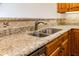 Close-up of a stainless steel dual bowl kitchen sink with granite countertops at 4061 Melbourne Dr, Columbus, IN 47203
