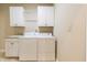 Laundry room with washer, dryer, sink, and white cabinets at 4061 Melbourne Dr, Columbus, IN 47203