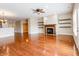 Open living room featuring hardwood floors, fireplace, and ceiling fan at 4061 Melbourne Dr, Columbus, IN 47203