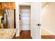 Spacious, organized pantry with adjustable shelving next to a stainless steel refrigerator at 4061 Melbourne Dr, Columbus, IN 47203