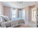 Bedroom with natural light, window views, ensuite bathroom, and closet at 4722 E Shadowbrook Dr, Camby, IN 46113