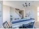 Bright dining room featuring modern chandelier, table with blue runner and seating for six under staircase at 4722 E Shadowbrook Dr, Camby, IN 46113