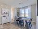 Stylish dining room showcasing a large window, modern chandelier, and seating for six at 4722 E Shadowbrook Dr, Camby, IN 46113
