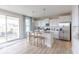 Open kitchen featuring an island with seating, stainless appliances, and sliding door to an outdoor patio at 4722 E Shadowbrook Dr, Camby, IN 46113
