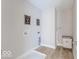 Well-lit laundry room featuring stylish decor and durable wood-look floors at 4722 E Shadowbrook Dr, Camby, IN 46113